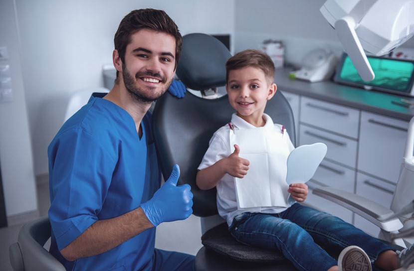 happy dentist and kid happy dentist and kid